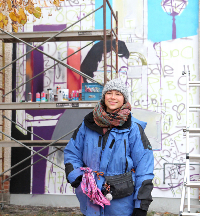Artist battling elements to create mural