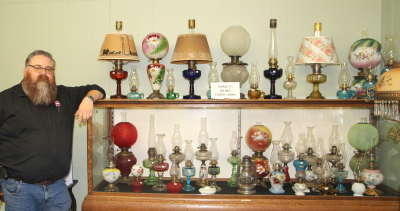 Brandt Bessant with a small number of his antique lamps on display this summer at Beckoning Hills Museum. 