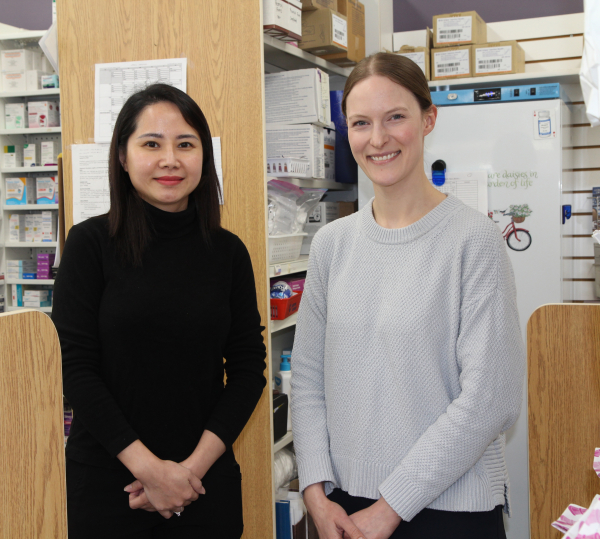 Hien Ha (left) with Megan Hamilton behind the counter at Hazlewood Drugs in Boissevain. A native of Vietnam, she will be in town until the end of May dispensing medications before eventually heading home with memories of the town and its people.