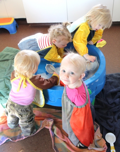 Kaylee DeYaegher plays in the water table with her friends at Mini Mustang Corral in Minto.