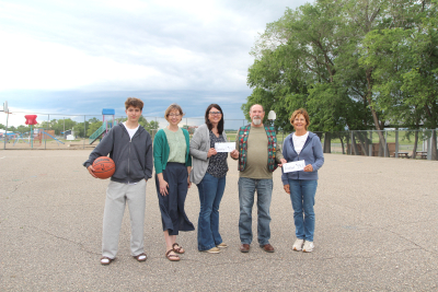 The Boissevain Lions Club are commited to the new high school sport space, giving two $4,500 donations to the project – one for basketball, one for pickleball for a total of $9,000. Standing in future sport space and accepting the donation were (L-R): Young basketball player Sidney Dueck, Susan Jackson and Heather Janssens, co-chairs of the playground committee, Boissevain Lions Club President Doug Robertson and Elaine Vandoorne of the Boissevain Pickleball Players Club. After building the middle school play area last year, the committee moved to work on the high school area, which will include basketball and pickleball courts, and should be finished this summer.    
