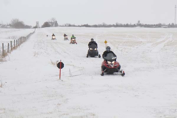 A group of local snowmobilers took advantage of the break in weather, using the new SnoMan access trail west of town to take a little trip on Saturday, February 3. Paul Hamilton, Keith Hole, Greg Graham, Brad Shaw and Scott Pierce left at 1:00pm on a snowmobile trip that took them from Boissevain to Lake Metigoshe, then to the west side of the Turtle Mountains. They made a stop at Deloraine, back to Lake Metigoshe and from there returned to Boissevain. Overall, they were gone six hours and travelled about 100 miles.											     photo by lorraine houston