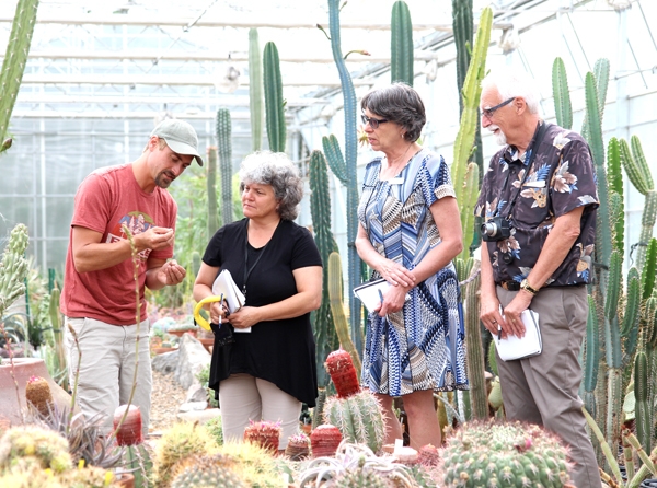 Peace Garden Horticulturalist Johannes Olwage shows a cacti flower to Communities in Bloom judges, (l-r) Marylaine de Chantal from Sainte-Angèle-de-Monnoir, Québec, Shawna Phillips from Killarney, Manitoba, and Larry Hall from Buena Vista, Saskatchewan, who spent Thursday, July 20 evaluating the International Peace Garden.