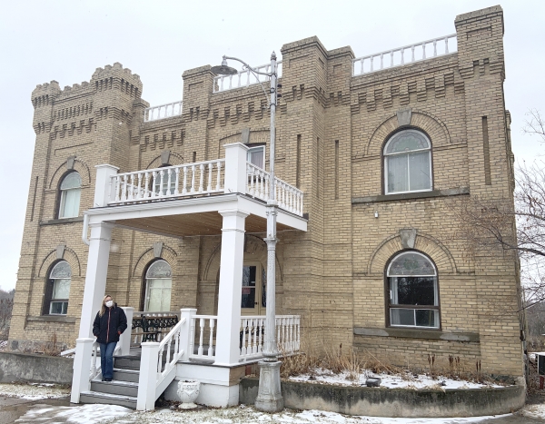 Board member Karen Kempe stands on the steps of the famous Hillcrest Museum on March 9. The historical building, which became a museum in 1967, has suffered a fair bit of water damage, with a preliminary estimate of $80,000 to repair the roofs. Among its displays are 5,000 butterflies. They are looking at holding a Reach for the Top fundraiser to help with costs.
