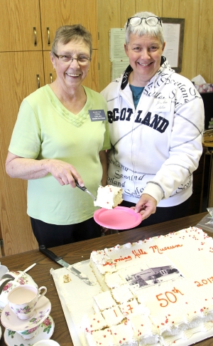 Museum President Donna Garland and Volunteer Jo-Ann Saban cut and serve cake at the celebration.